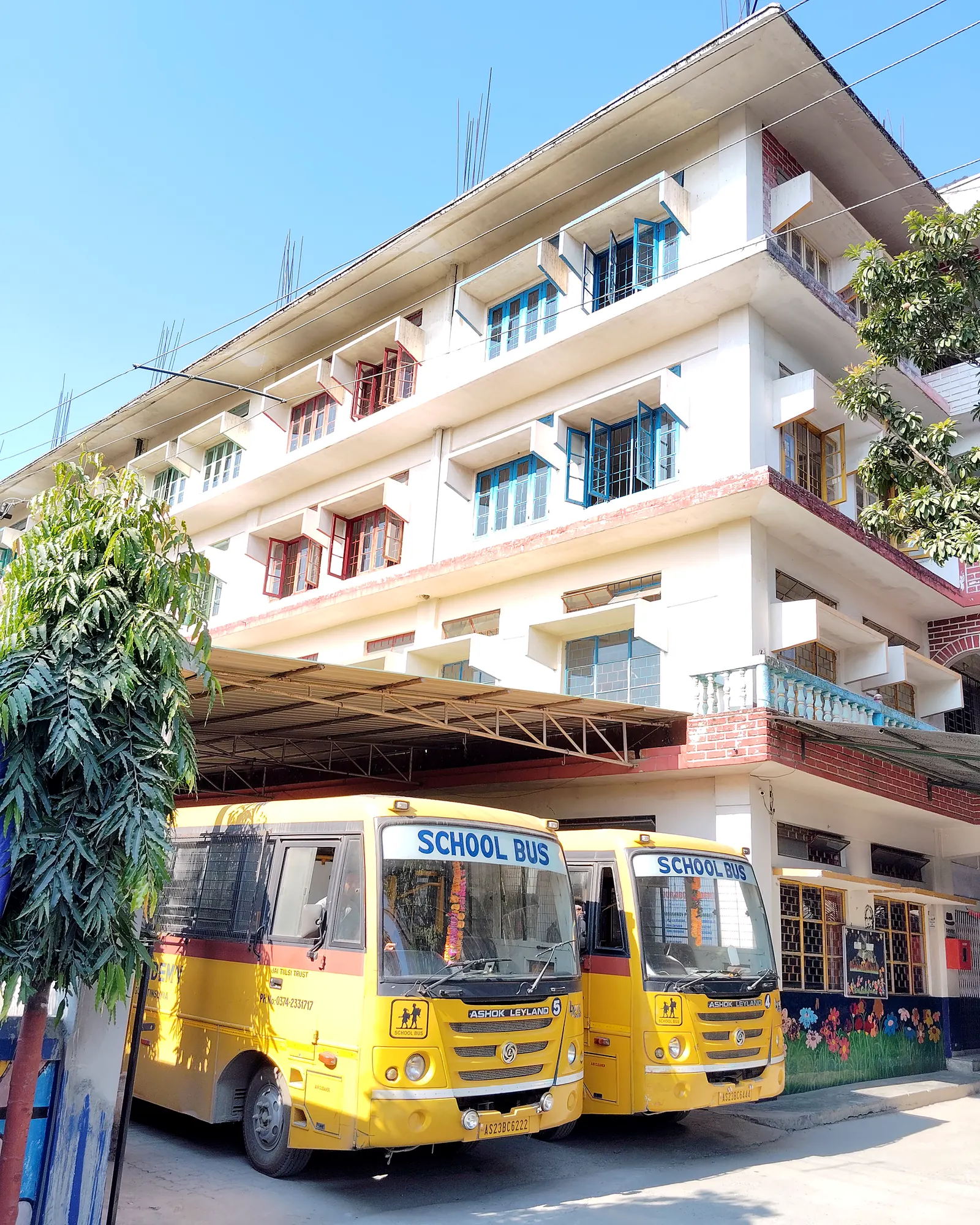 The school building, with the school buses