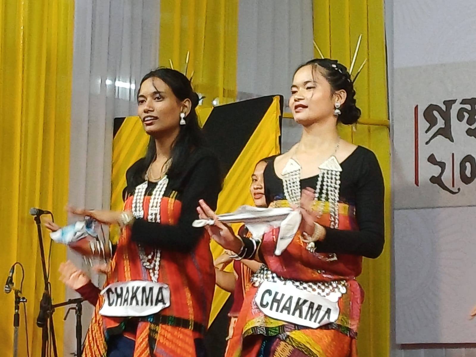 Two students in Chakma traditional dress on stage