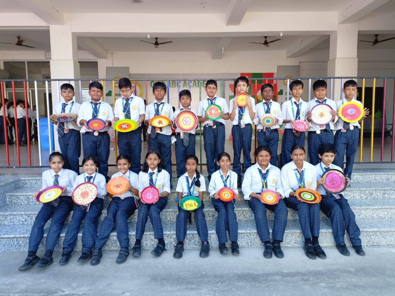 Class students holding decorated thalis